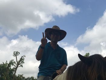 Woman wearing hat against sky