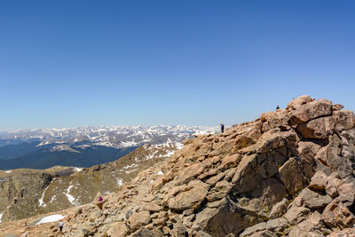 Scenic view of mountains against clear blue sky