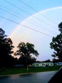 Rainbow over landscape against clear sky