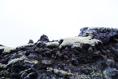 Low angle view of rock formation against clear sky