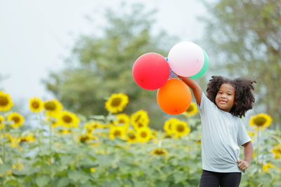 Happy girl holding balloons