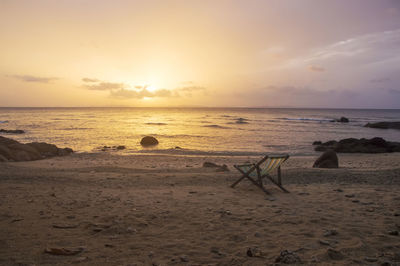 Scenic view of beach against sky during sunset