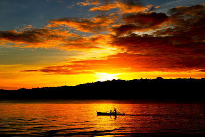 Silhouette of boat at sunset