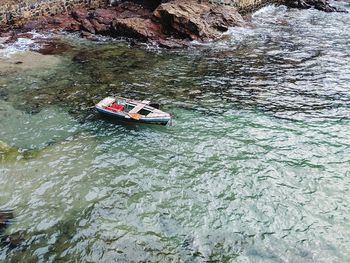 High angle view of boat on rock