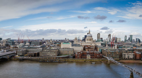 View of cityscape against cloudy sky
