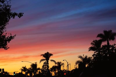 Silhouette palm trees against sky at sunset