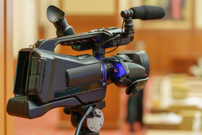 Video camera in business conference room recording participants and speaker, seminar meeting,