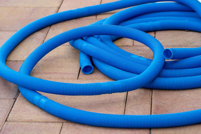 High angle view of blue hose on floor