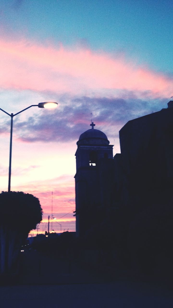 sunset, silhouette, architecture, building exterior, built structure, sky, orange color, cloud - sky, dusk, cloud, low angle view, street light, dramatic sky, tower, guidance, lighthouse, outdoors, nature, cloudy, beauty in nature