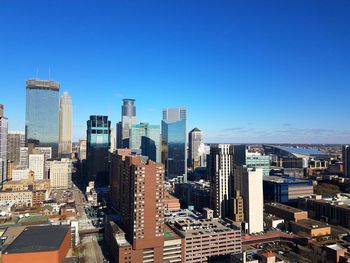 Skyscrapers in city against blue sky