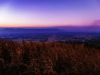 Scenic view of land against sky during sunset
