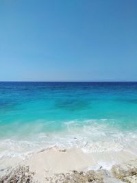 Scenic view of sea against clear blue sky