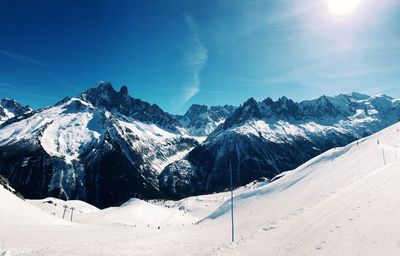 Scenic view of snowcapped mountains against sky