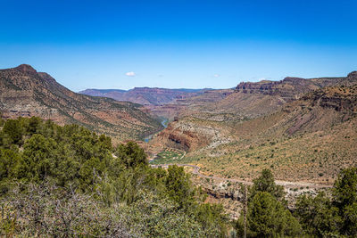 Scenic view of mountains against blue sky