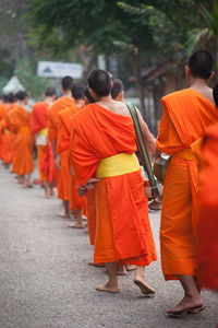 Rear view of people walking in temple