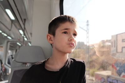 Cute boy sitting in bus