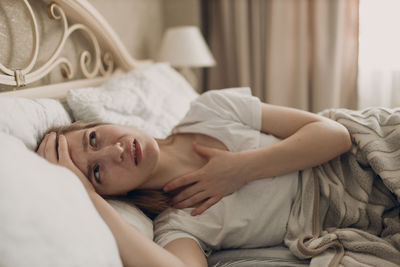 Young woman sleeping on bed at home