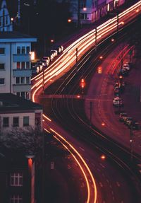 High angle view of light trails on road in city at dusk