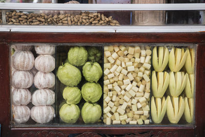 Close-up of fruits in display cabinet at store