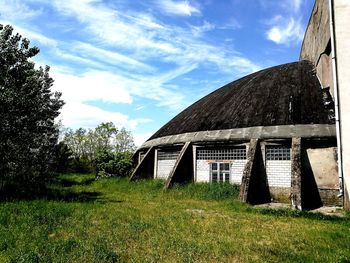 Built structure on field against sky