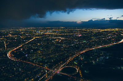 High angle view of illuminated city buildings against sky