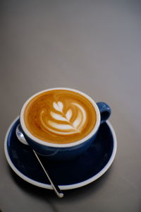 Awesome latte art hot coffee drink on table in coffee shop cafe