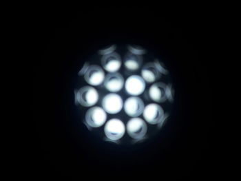 Close-up of illuminated light bulb in darkroom