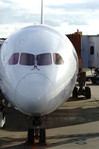 Airplane on airport runway against sky