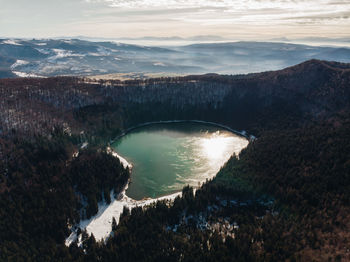 High angle view of sea and mountains against sky