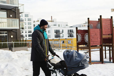 Man standing in city during winter