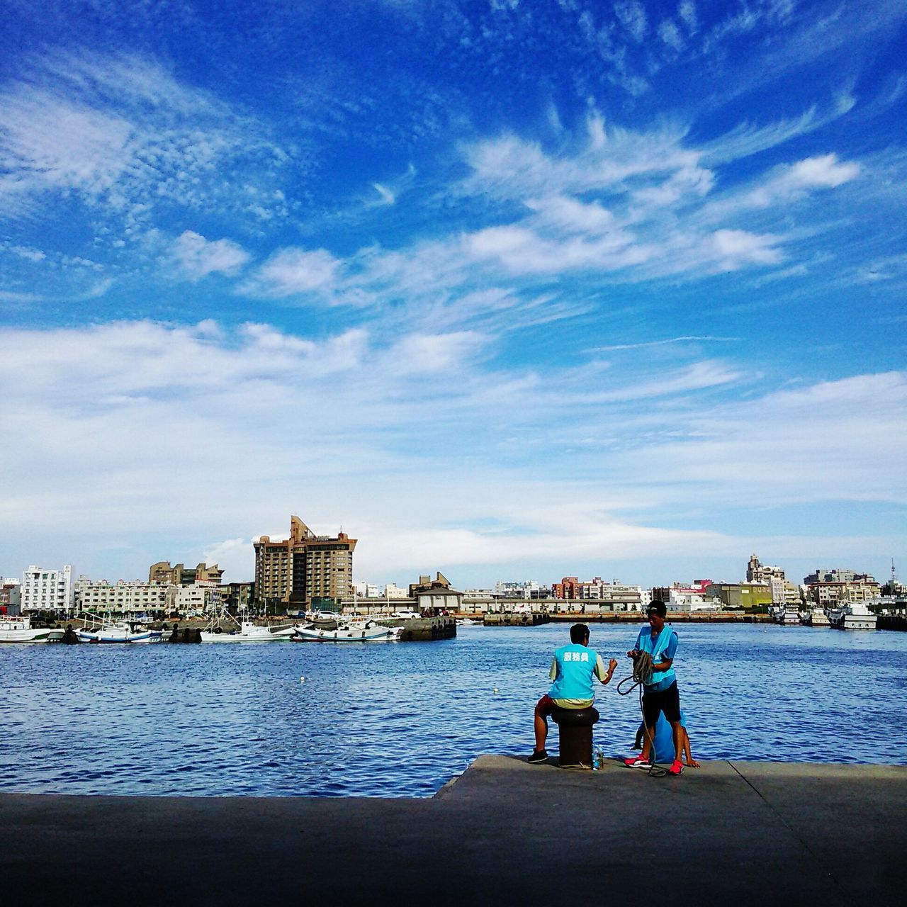 water, lifestyles, leisure activity, sky, rear view, men, togetherness, sea, sitting, person, bonding, standing, pier, cloud - sky, full length, boys, childhood, love