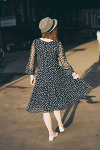 Rear view of woman walking outdoors