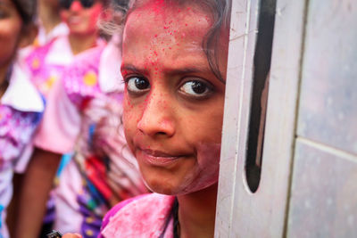 Close-up portrait of young woman during holi