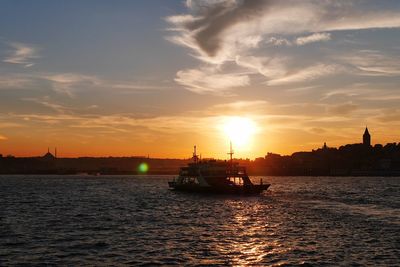 Silhouette ship sailing on sea against sky during sunset