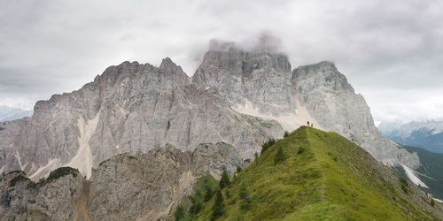 Scenic view of mountains against cloudy sky