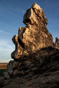 Low angle view of rock formations against sky