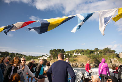 People flying kite against clear sky