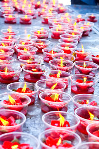 Close-up of lit tea light candles in temple