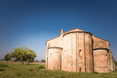 Built structure on field against clear sky