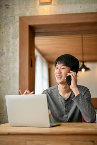 Young woman using laptop at home