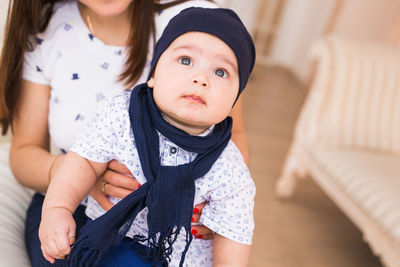 Close-up of cute baby girl at home