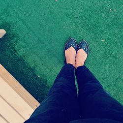 Low section of woman standing on turf