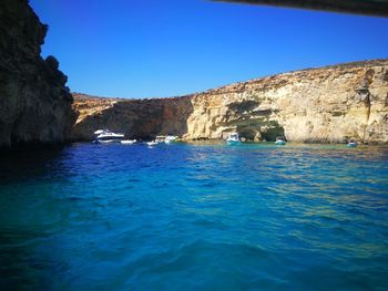 Scenic view of sea against clear blue sky