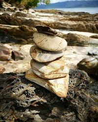 Close-up of stack of rocks at shore