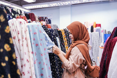 Rear view of woman standing in store