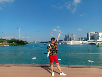 Full length of young woman doing yoga in city