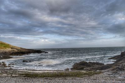 Scenic view of sea against storm clouds