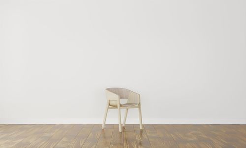 Empty chair against white wall at home