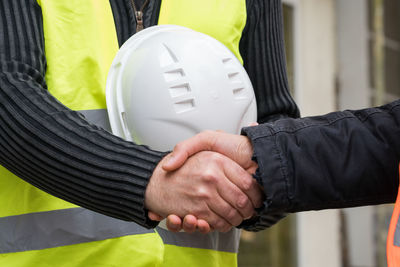 Close-up of architects shaking hands