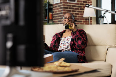 Woman drinking beer at home